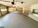Clean garage with painted floor, shelving, and ample storage space at 5445 Maltdie, Sugar Hill, GA 30518