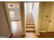 Hallway shows hardwood floors connecting living areas and the stairway leading upstairs at 5445 Maltdie, Sugar Hill, GA 30518