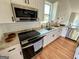 Beautiful kitchen with granite counters, stainless steel appliances, and crisp white cabinetry at 5445 Maltdie, Sugar Hill, GA 30518