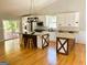 Bright kitchen with stainless steel appliances, granite countertops, white cabinets, wood island, and natural light at 5445 Maltdie, Sugar Hill, GA 30518