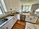 Charming kitchen with granite countertops, white cabinets, and stainless steel appliances at 5445 Maltdie, Sugar Hill, GA 30518