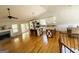 Open concept kitchen with white cabinets, granite countertops, a wooden island, stainless steel appliances, and hardwood floors at 5445 Maltdie, Sugar Hill, GA 30518