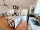 Spacious open concept featuring a granite kitchen island, stainless appliances, and hardwood floors at 5445 Maltdie, Sugar Hill, GA 30518