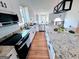 Bright kitchen with granite countertops, stainless steel appliances, subway tile backsplash, and an island at 5445 Maltdie, Sugar Hill, GA 30518
