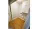 Laundry room with white cabinetry and laminate wood flooring at 5445 Maltdie, Sugar Hill, GA 30518