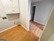 Laundry room with white cabinets, vinyl flooring, and connections for a washer and dryer at 5445 Maltdie, Sugar Hill, GA 30518