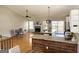 Bright living area boasts hardwood floors, a granite kitchen island, a fireplace, and access to the deck at 5445 Maltdie, Sugar Hill, GA 30518