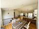 Open-concept living space featuring hardwood floors, an island kitchen, and a staircase to the upper level at 5445 Maltdie, Sugar Hill, GA 30518