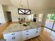 Open living area with vaulted ceilings includes a granite kitchen island, fireplace, and a deck at 5445 Maltdie, Sugar Hill, GA 30518