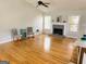 Open living room features hardwood floors, fireplace, and natural light from the windows at 5445 Maltdie, Sugar Hill, GA 30518