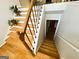 A staircase with wood treads, white risers, and a black metal railing leads to the upper level at 5445 Maltdie, Sugar Hill, GA 30518