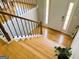 Stairway featuring hardwood steps and wood railing at 5445 Maltdie, Sugar Hill, GA 30518