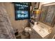 Bathroom with a sink, toilet, and mirror with a shelf for storage and decor at 6233 Castlewood Dr, Morrow, GA 30260