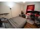 Cozy bedroom featuring hardwood floors, ceiling fan, and red curtains at 6233 Castlewood Dr, Morrow, GA 30260