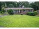 Charming one-story brick home featuring a covered front entrance and a well-manicured lawn at 6233 Castlewood Dr, Morrow, GA 30260