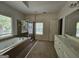 Spacious bathroom featuring a jetted tub, glass-enclosed shower, and a double vanity at 7235 Thoreau Cir, Atlanta, GA 30349