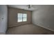 Cozy bedroom with carpet, a ceiling fan, and a window providing natural light at 7235 Thoreau Cir, Atlanta, GA 30349