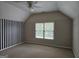 Unique bedroom with a striped accent wall, a ceiling fan, carpet, and a window at 7235 Thoreau Cir, Atlanta, GA 30349