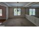 Elegant dining room with classic chandelier, wainscoting, a large window and a mirrored wall at 7235 Thoreau Cir, Atlanta, GA 30349