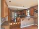 Well-lit kitchen featuring wood cabinetry, an island, stainless steel appliances, and a breakfast bar at 7235 Thoreau Cir, Atlanta, GA 30349