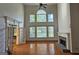 Bright living room with a cozy fireplace, large windows, hardwood floors, and an open layout at 7235 Thoreau Cir, Atlanta, GA 30349