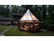 Backyard patio area with a wooden pergola, string lights, and a grilling area - perfect for entertaining at 4567 Town Crier Sw Rd, Lilburn, GA 30047