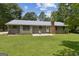 Home with a metal roof and a large backyard at 147 Pine St, Covington, GA 30014