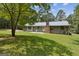 Home with a metal roof and a large backyard at 147 Pine St, Covington, GA 30014