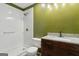 Bathroom with a granite-topped dark wood vanity and a shower stall at 147 Pine St, Covington, GA 30014