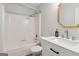 Updated bathroom boasts a shower-tub, and modern vanity at 147 Pine St, Covington, GA 30014