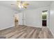 Bedroom with ceiling fan and neutral color scheme leads to bathroom and living area at 147 Pine St, Covington, GA 30014