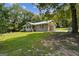Inviting home with an attached garage and charming front porch surrounded by mature trees at 147 Pine St, Covington, GA 30014