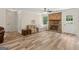 Bright living room featuring hardwood floors, a brick fireplace, and a ceiling fan at 147 Pine St, Covington, GA 30014