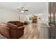 Cozy living room with a brick fireplace, ceiling fans, and wood-look floors at 147 Pine St, Covington, GA 30014