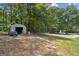 Property with a storage shed and wooded area at 147 Pine St, Covington, GA 30014