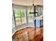 Dining area featuring hardwood floors, large windows, modern light fixture and views to the yard at 398 Mckenzie Dr, Stockbridge, GA 30281