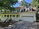 Charming two-story home with a welcoming front porch and a spacious two-car garage at 398 Mckenzie Dr, Stockbridge, GA 30281