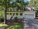 Lovely two-story home featuring a large front porch and attached two-car garage at 398 Mckenzie Dr, Stockbridge, GA 30281