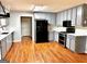 Modern kitchen features stainless steel appliances, gray cabinetry, tile backsplash and wood-look floors at 398 Mckenzie Dr, Stockbridge, GA 30281
