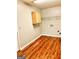 The laundry room area features hardwood floors and ample cabinet space at 398 Mckenzie Dr, Stockbridge, GA 30281