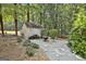 Cozy backyard shed and fire pit surrounded by lush landscaping and a wooded setting at 100 Old Plantation Way, Fayetteville, GA 30214