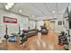 Expansive basement area with a workout area, sofa, and a sliding barn door at 100 Old Plantation Way, Fayetteville, GA 30214