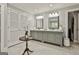 Elegant bathroom with double vanity, grey cabinets, and modern lighting fixtures at 100 Old Plantation Way, Fayetteville, GA 30214