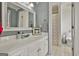 Bright bathroom features white cabinets, framed mirror and opens up to a full bath and toilet at 100 Old Plantation Way, Fayetteville, GA 30214