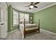 Comfortable bedroom with green walls, crown molding, and natural light at 100 Old Plantation Way, Fayetteville, GA 30214