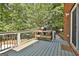 Deck features a grill and overlooks a backyard with mature trees, offering a serene outdoor space at 100 Old Plantation Way, Fayetteville, GA 30214