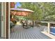Spacious deck with gazebo, lounge furniture, grill and stairs descending to backyard pool area at 100 Old Plantation Way, Fayetteville, GA 30214