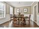 Elegant dining room featuring a classic wooden table set, wainscoting, and natural light at 100 Old Plantation Way, Fayetteville, GA 30214