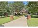 A long driveway leads to a beautiful home surrounded by lush greenery at 100 Old Plantation Way, Fayetteville, GA 30214