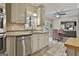 Bright kitchen with granite countertops, stainless steel appliances, and a view of the dining area at 100 Old Plantation Way, Fayetteville, GA 30214